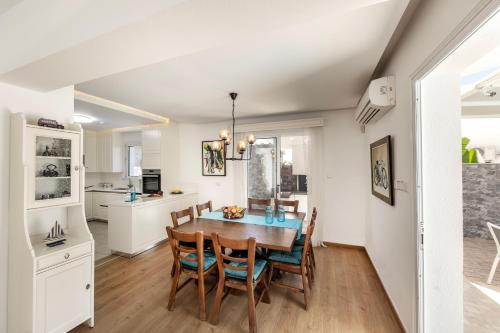 a kitchen and dining room with a table and chairs at Accomoteleia Crystal Lagoon Villa in Protaras