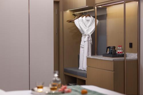 a bathroom with a towel hanging on a mirror at Shenzhen Zhongchen International Hotel - Shenzhen Baolong Subway Station Branch in Shenzhen