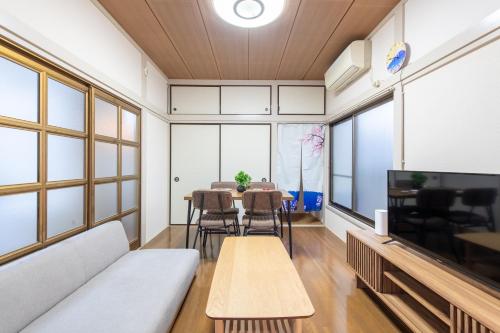 a living room with a couch and a table at 神谷戸建 in Tokyo