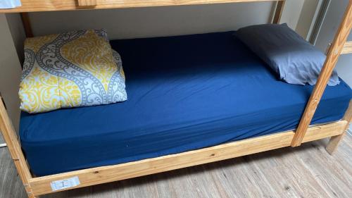 a bunk bed with a blue mattress and a pillow at Robertson's Place Like Home in Los Angeles