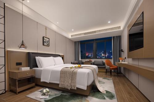 a hotel room with a bed and a window at Shenzhen Zhongchen International Hotel - Shenzhen Baolong Subway Station Branch in Shenzhen