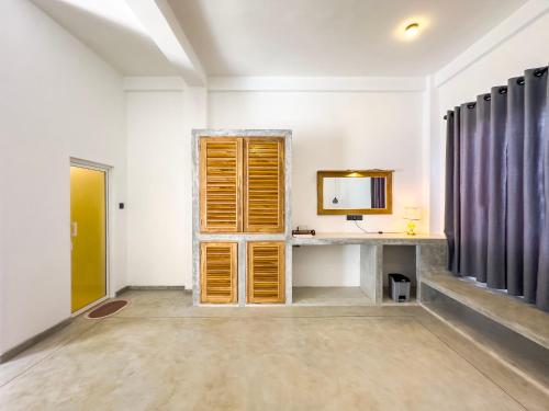 a room with a desk and a mirror at Moringa Mirissa in Mirissa