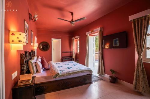 a bedroom with red walls and a bed in it at Zostel Jodhpur (Ratanada) in Jodhpur