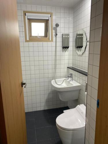 a bathroom with a toilet and a sink at 38th Street Guesthouse in Mokpo