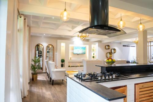 a kitchen with a stove and a living room at 41 Haven in Nairobi