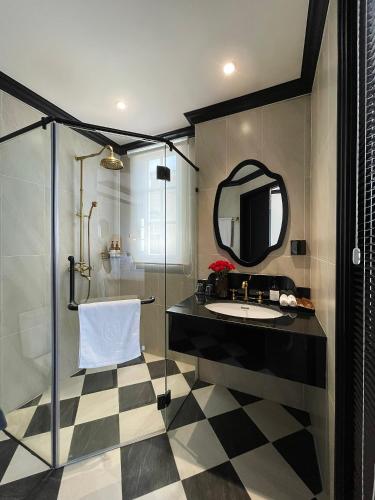 a bathroom with a sink and a mirror at Le Bonheur Hotel in Phú Quốc