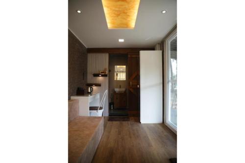 a kitchen with wooden floors and a ceiling at Out of Box Living Kashid,Murud in Kashid