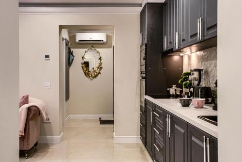 a kitchen with black cabinets and a wreath on the door at Sika DeLuxe Apartment in Arad