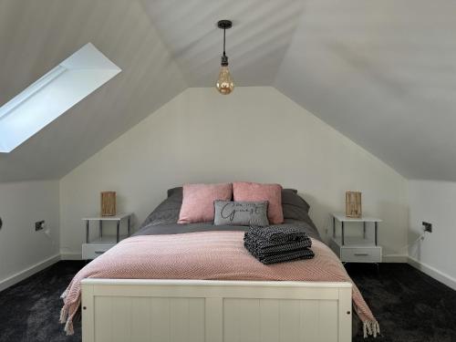 a bedroom with a large bed in a attic at Brooke View Barns No 1 in Norwich