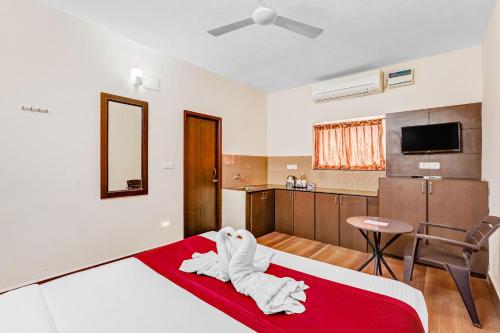 a hotel room with a bed and a kitchen at Season 4 Residences -Thiruvanmiyur Near Tidel park Apollo Proton cancer center and IIT Madras Research Park in Chennai