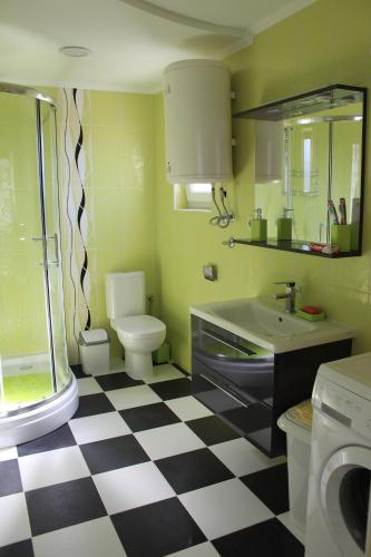 a bathroom with a black and white checkered floor at Lilac Apartments in Trogir