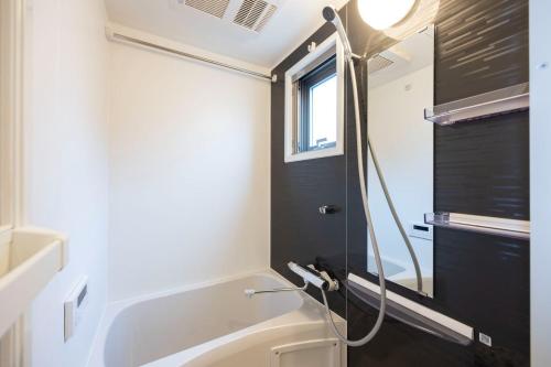 a bathroom with a shower and a toilet in it at Mat Hikifune in Tokyo