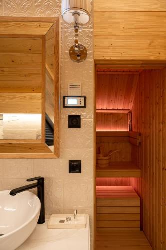 a bathroom with a sink and a mirror at Chaletovo Mountain Residences in Zakopane