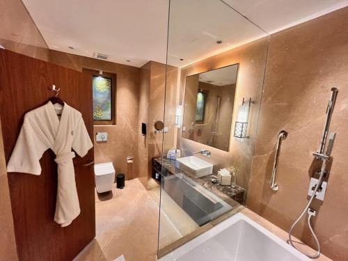 a bathroom with a tub and a sink and a shower at Vivanta Tawang in Tawang