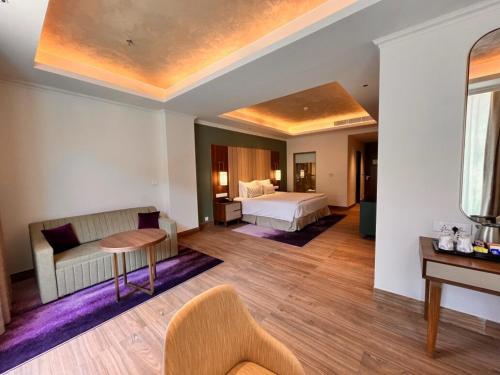 a hotel room with a bed and a table at Vivanta Tawang in Tawang