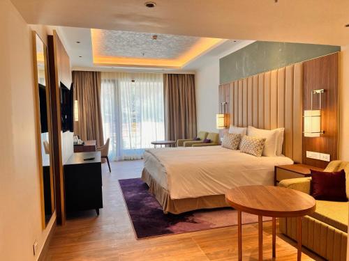 a hotel room with a bed and a living room at Vivanta Tawang in Tawang