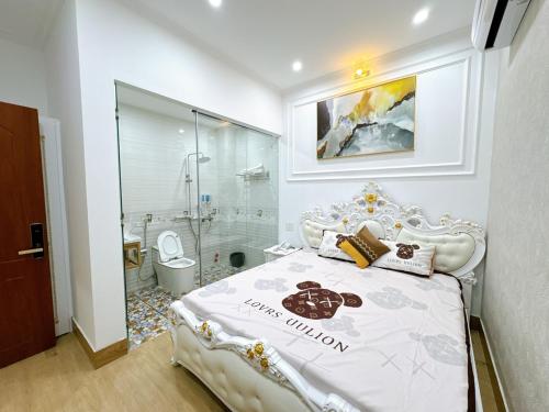 a bedroom with a white bed and a shower at Sky Star 2 Hotel in Can Tho