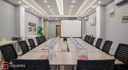 a conference room with a long table and chairs at Jumbaktas Astana Hotel in Astana