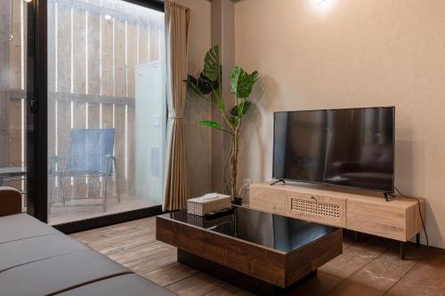 a living room with a flat screen tv on a stand at 船堀戸建 in Tokyo