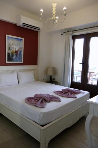 a bedroom with a bed with towels on it at Eleni Boutique Apartment in Lindos
