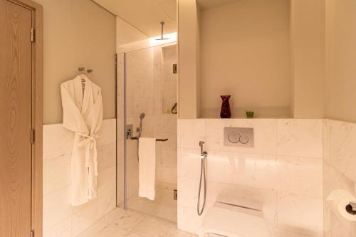 a bathroom with a shower with a glass door at The Palm Tower in Dubai