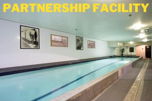 a swimming pool in a gym with the words participation facility at Hotel 115 in Christchurch