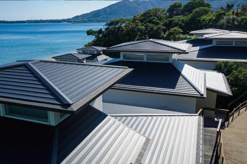 a row of houses next to a body of water at Miru Amami in Tatsugo