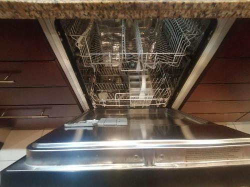 a dishwasher with its door open in a kitchen at Burj Views Tower c, Downtown,Dubai UAE in Dubai
