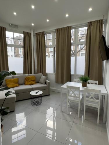 a living room with a couch and a table at Stylish Flat in Camden/KingsCross in London