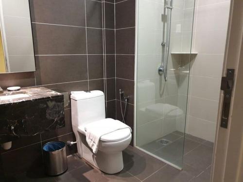 a bathroom with a toilet and a glass shower at MetraSquare 308 Easy Suite in Malacca