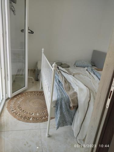 a bedroom with a bed and a walk in shower at Budget Studio by the Sea in Perea