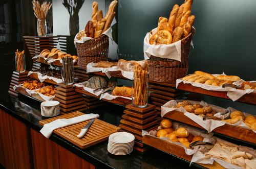 a buffet of bread and pastries on a table at Hilton Baku in Baku