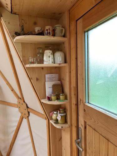 a shelf in a tiny house with a window at Geo Dome in Hochdorf-Assenheim