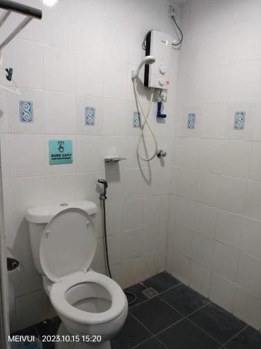 a bathroom with a toilet and a shower at May Room Semporna in Semporna