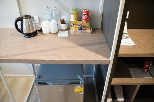 a shelf in a refrigerator with food on it at The Rise Suites Hotel, Chiang Mai - SHA Extra Plus in Chiang Mai