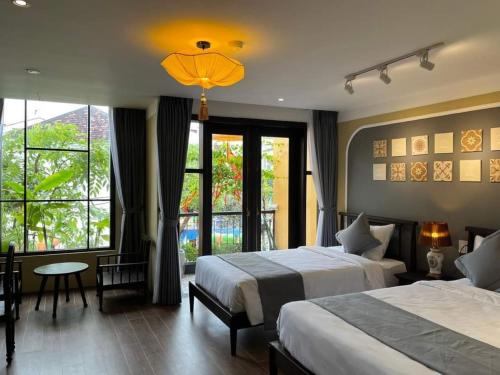 Postel nebo postele na pokoji v ubytování Hoianan Boutique Hotel