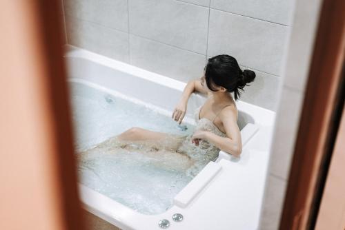 a woman is sitting in a bath tub at And spring in Jeonju