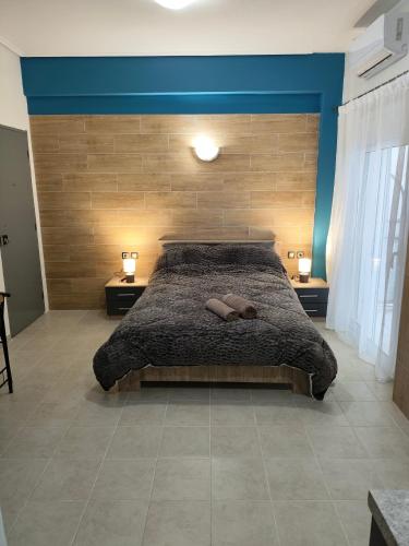 a bedroom with a large bed with two night stands at GM 7 ROOMS KENTRO στην καρδιά της πόλης in Larisa