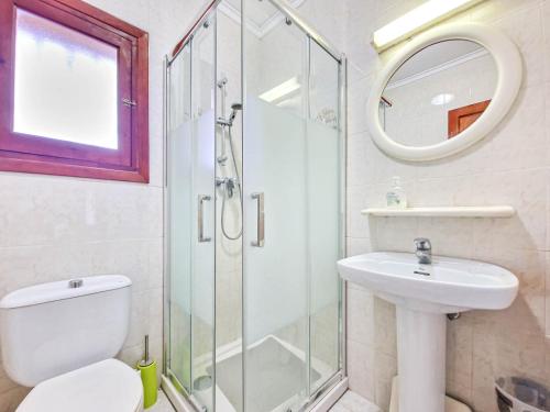 a bathroom with a shower and a toilet and a sink at Casa Fortunata in Benitachell