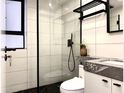 a bathroom with a shower and a toilet and a sink at Shanghai Jing'an Temple Quality 3 bedrooms Alarming and quiet Commercial area Convenient transportation in Shanghai
