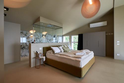 1 dormitorio con 1 cama grande y espejo en Loft con piscina e utilizzo esclusivo SPA privata a Carobais 7, en Almenno San Bartolomeo