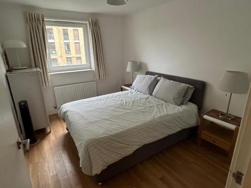 a bedroom with a bed and a window at Kingston Flat in Kingston upon Thames