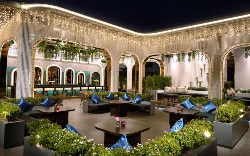 a lobby with couches and tables and plants at Koulen Central Hotel in Siem Reap
