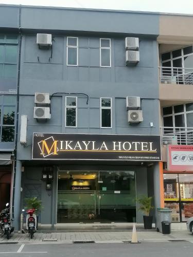 a building with a sign for a kiyaasha hotel at Mikayla hotel in Port Dickson