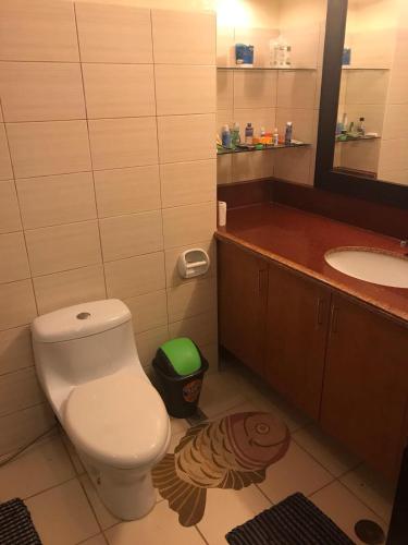 a bathroom with a toilet and a sink at Condo Unit in Alta Vista de Boracay Hotel in Boracay