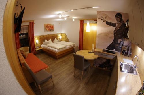 a living room with a room with a bed and a table at Appartement Wälderhof in Kaprun