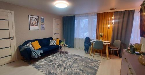 a living room with a blue couch and a table at The Best Choice Narva Center in Narva