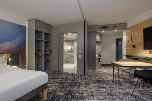 a hotel room with a bed and a desk at Novotel Suites Berlin City Potsdamer Platz in Berlin