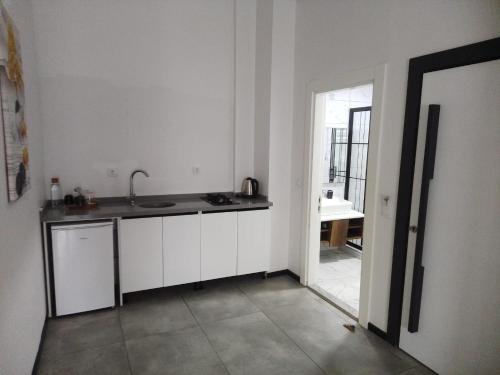 a kitchen with white cabinets and a sink at WB Weekend Otel in Bodrum City