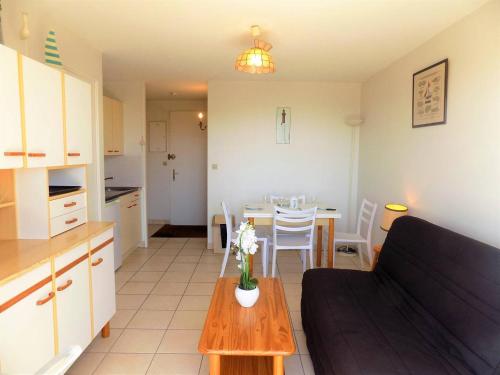 a living room and kitchen with a table and a couch at Royan - APPARTEMENT VUE MER - à SEULEMENT 300m PLAGE et COMMERCES in Royan